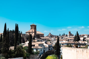 Fototapeta na wymiar Granada,Spain. April 14, 2022: Albaicin neighborhood San Ildefonso Cathedral with blue sky.