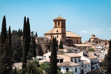 Granada,Spain. April 14, 2022: Albaicin neighborhood San Ildefonso Cathedral with blue sky. - obrazy, fototapety, plakaty
