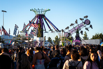 A Crowd hanging out at a fall festival. Midday. Nevada.
