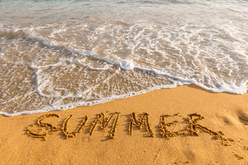 Summer inscription on sandy beach