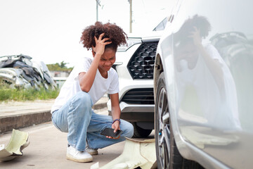 A teenage girl sits stressed after a car crash on the road. The concept of traffic accidents and insurance.