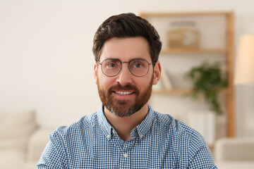 Happy man having video call at home, view from web camera