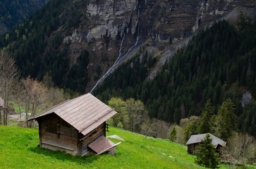 Picturesque view of valley with houses, pathway and forest in mountains
