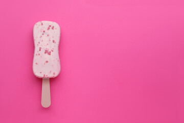 Delicious glazed ice cream bar on pink background, top view. Space for text