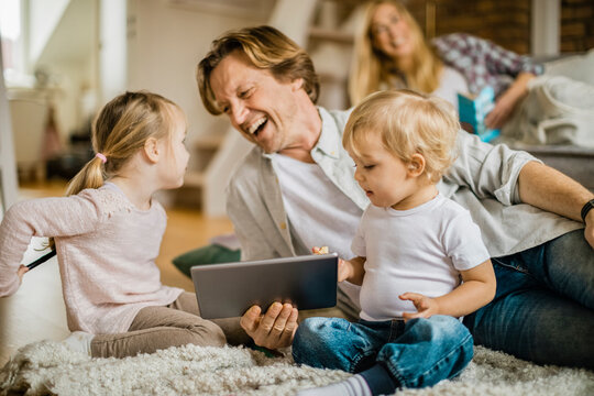 Family at home using a digital tablet in the living room