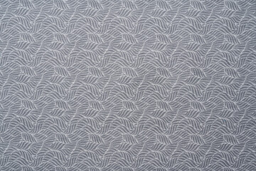 Light gray fabric texture with an abstract pattern.