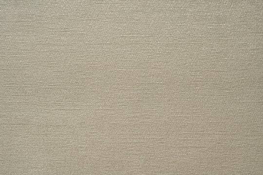 Light-colored fabric texture with an abstract pattern.