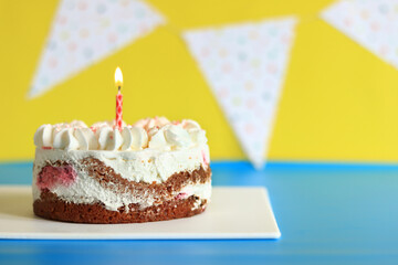 Festive birthday cake. Cake with a candle. Cake on a festive background. Happy birthday