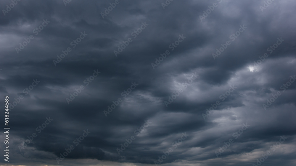 Poster the dark sky with heavy clouds converging and a violent storm before the rain.bad or moody weather s