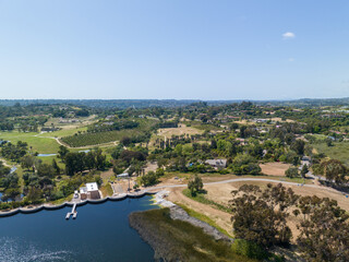 Aerial view over water reservoir and a large dam that holds water. Rancho Santa Fe in San Diego, California, USA