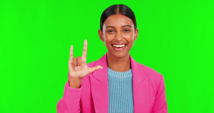 Face, woman and sign language of love on green screen for emotion, care or hope. Rock emoji, horn hands or portrait of indian female person with positive gesture of kindness, joy or support in studio
