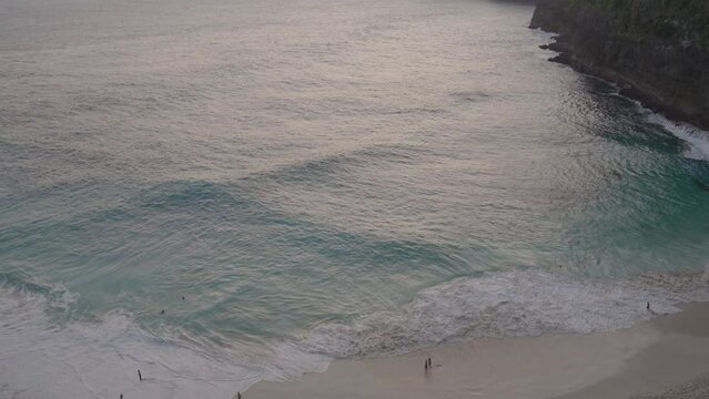 High Angle View of Blue Sea Water, Big Giant Waves, Strong Tides, Dangerous Yet Beautiful at Kelingking Beach Nusa Penida Bali Indonesia During Sunset