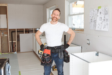 Carpenter Installing Luxury Modern Fitted Kitchen in house