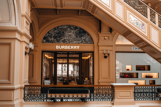 Beige classy facade of Burberry boutique inside the famous shopping mall in Moscow GUM. Burberry is a luxurious clothing brand based in Great Britain
