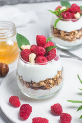 Granola with yogurt and raspberries in a glass