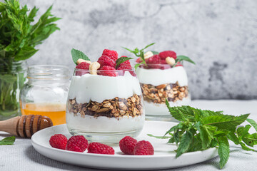 Granola with yogurt and raspberries in a glass