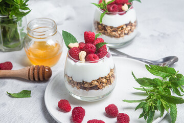 Granola with yogurt and raspberries in a glass