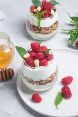 Granola with yogurt and raspberries in a glass