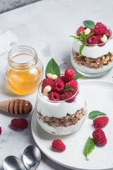 Granola with yogurt and raspberries in a glass