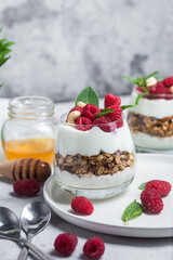 Granola with yogurt and raspberries in a glass