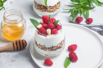 Granola with yogurt and raspberries in a glass