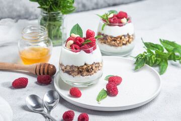 Granola with yogurt and raspberries in a glass