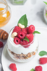 Granola with yogurt and raspberries in a glass