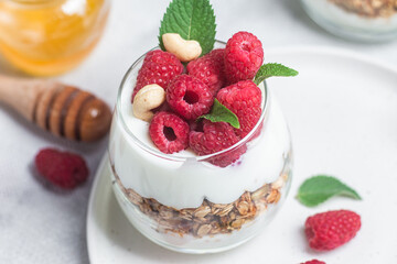 Granola with yogurt and raspberries in a glass