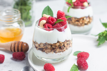 Granola with yogurt and raspberries in a glass