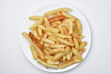 French fries on a white plate and sauce. Delicious breakfast of fried potatoes.