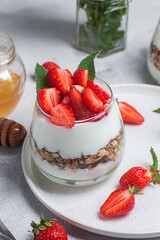 Granola with yogurt and strawberries in a glass