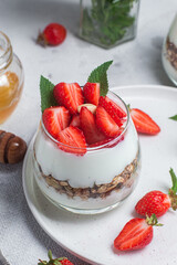 Granola with yogurt and strawberries in a glass
