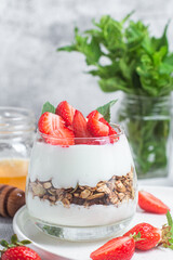 Granola with yogurt and strawberries in a glass