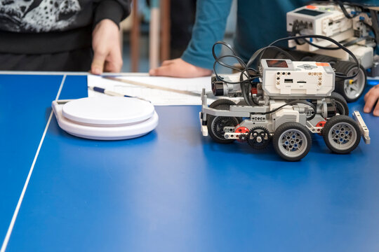A robot for educational robotics. Robotics competitions. A child's palm creates an obstacle for the robot's sensors