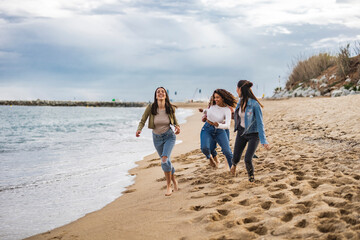 diverse women running on the beach