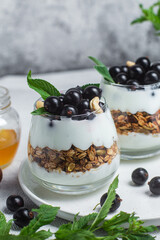Granola with yogurt and blackcurrant in a glass
