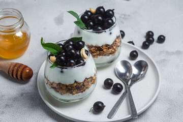 Granola with yogurt and blackcurrant in a glass