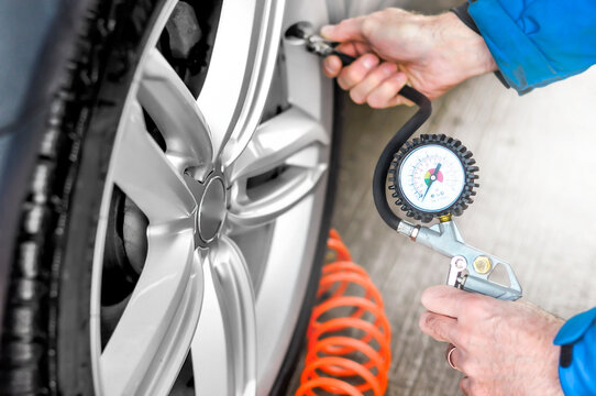 blowing a car tire with a compressor