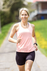 Female Runner Jogging during Outdoor Workout in a Park