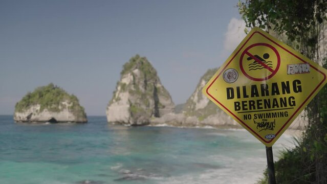 No Swimming Warning Sign at Diamond Beach Nusa Penida Bali Indonesia - Crystal Clear Water, Big Giant Waves, Strong Tides, Dangerous Yet Beautiful