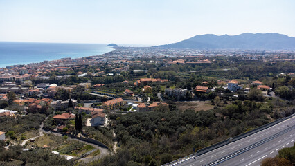 Drone footage looking over an Italian city towards the Mediterranean Sea in spring