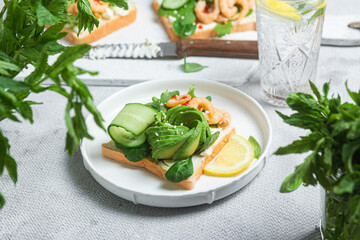 Sandwich with cream cheese, shrimp, avocado and cucumber