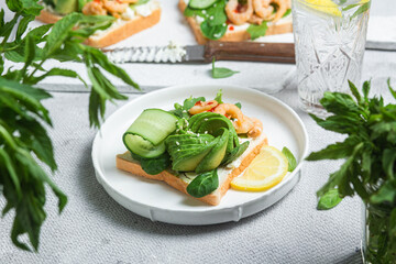 Sandwich with cream cheese, shrimp, avocado and cucumber