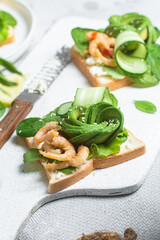 Sandwich with cream cheese, shrimp, avocado and cucumber