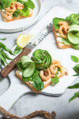 Sandwich with cream cheese, shrimp, avocado and cucumber