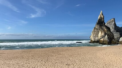 An empty wild sandy beach, Atlantic Ocean seascape, sea waves, beautiful cloudscape, dramatic landscape, travel content, Lisbon, Portugal