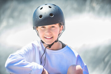 child girl playing skate or skateboard at parking to wearing safety helmet