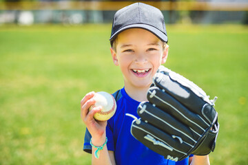 Young boy play baseball on summer day