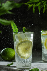 Cocktail with lemon and mint on a dark background. Lemonade