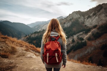 Naklejka premium Girl with camping backpack walking on trail in mountains with green vegetation, Generative AI